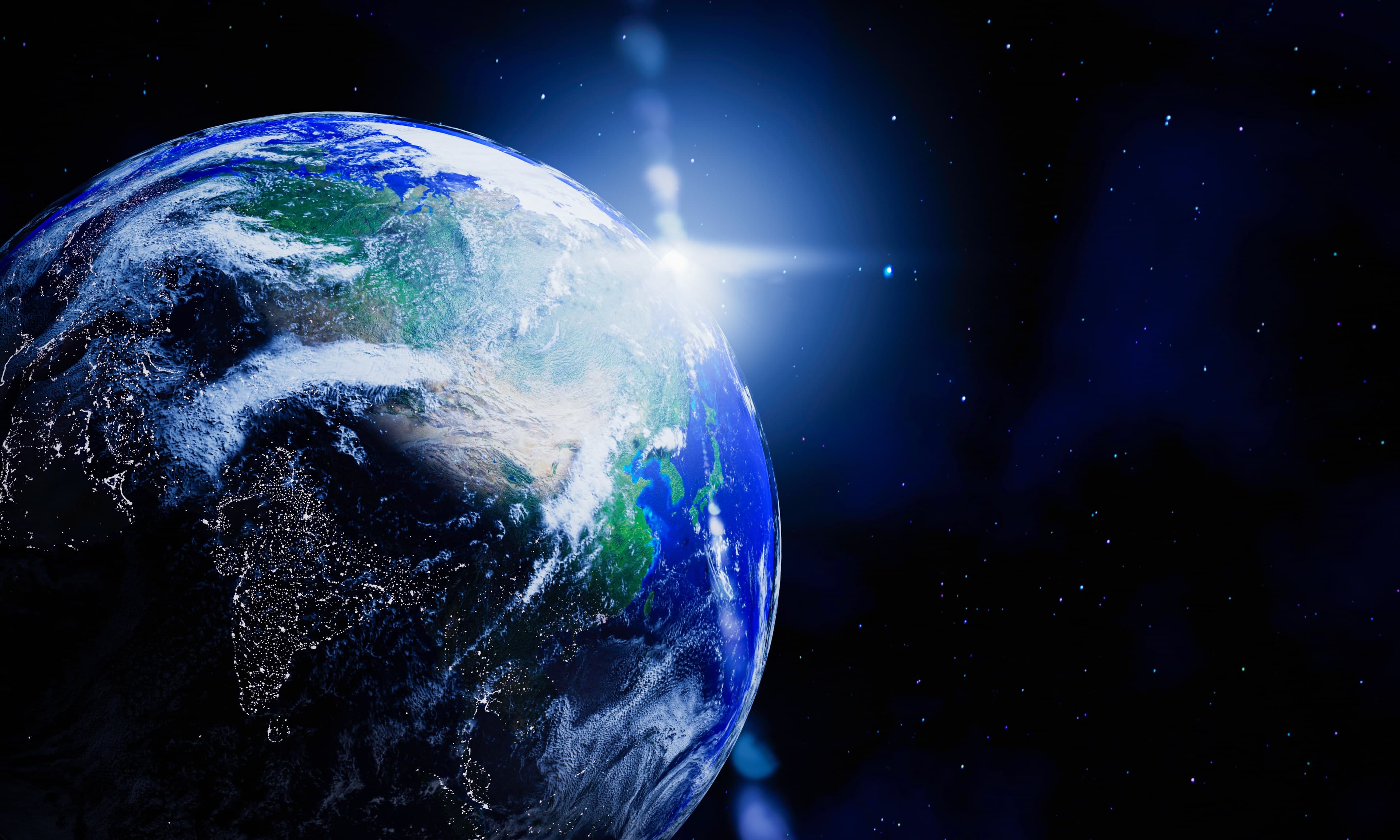 Planet Earth seen from space, lit by sunrise over the horizon